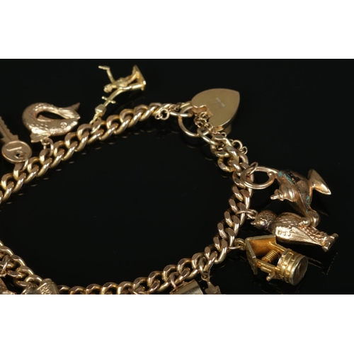 207 - A 9ct gold charm bracelet with mostly 9ct gold charms. Gross weight 36.54g.