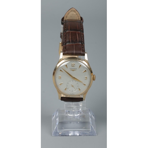 215 - A gents 9ct gold Longines manual wristwatch. Having subsidiary seconds and baton and Arabic numeral ... 