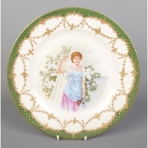 24 - A pair of Vienna porcelain plates. With scenes depicting maidens with flowers and having green and g... 