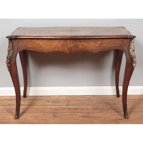 256 - An antique French walnut side table with strung inlay and ormolu mounts.