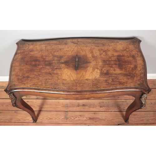 256 - An antique French walnut side table with strung inlay and ormolu mounts.