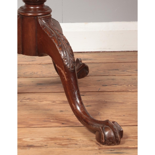 258 - A Georgian style carved mahogany tilt top table with pie crust top and raised on three ball and claw... 