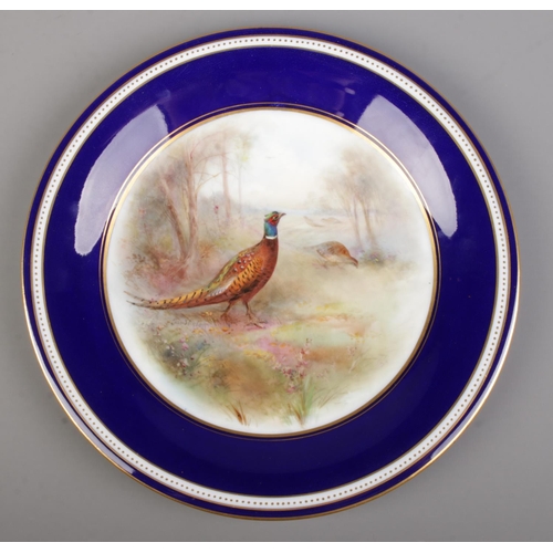 26 - James Stinton for Grainger & Co Worcester, a porcelain plate with hand painted woodland scene and tw... 