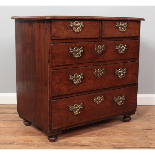 262 - A Georgian oak bachelors chest of two over three drawers. Height 73cm, Width 77cm, Depth 46cm.