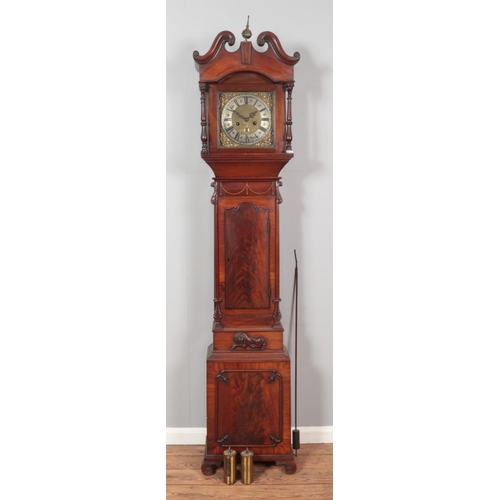 269 - A Georgian mahogany longcase clock. Having twin swan neck pediments, carved lion detail and satinwoo... 