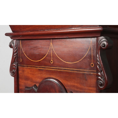 269 - A Georgian mahogany longcase clock. Having twin swan neck pediments, carved lion detail and satinwoo... 