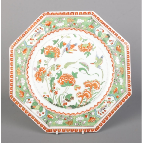 27 - A Rockingham octagonal plate decorated in the famille vert palette with birds and peonies. Diameter ... 