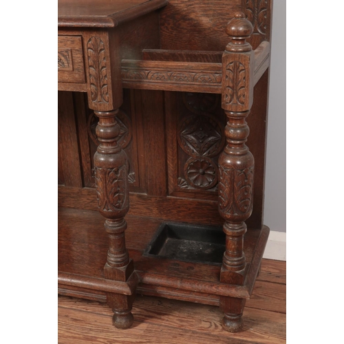 274 - An extensively carved oak hall stand. Height 216cm, Width 123cm, Depth 42cm.