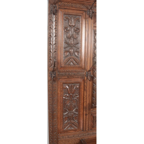 274 - An extensively carved oak hall stand. Height 216cm, Width 123cm, Depth 42cm.