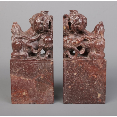 3 - A pair of Chinese carved hardstone bookends modelled as Dog of Fo/Temple Lions raised on plinths. He... 