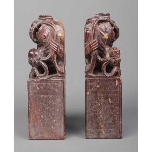 3 - A pair of Chinese carved hardstone bookends modelled as Dog of Fo/Temple Lions raised on plinths. He... 