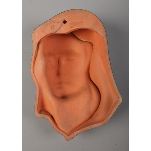 40 - A Goldscheider wall mask portrait of a lady in head scarf. Impressed to back 7831. 22cm.