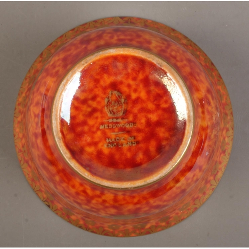 45 - A Wedgwood Lustre miniature bowl by Daisy Makeig Jones, decorated with motifs. Having mottled orange... 