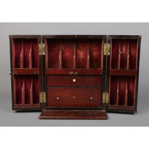 63 - An early 19th century mahogany apothecary cabinet with double door front. Having brass campaign styl... 