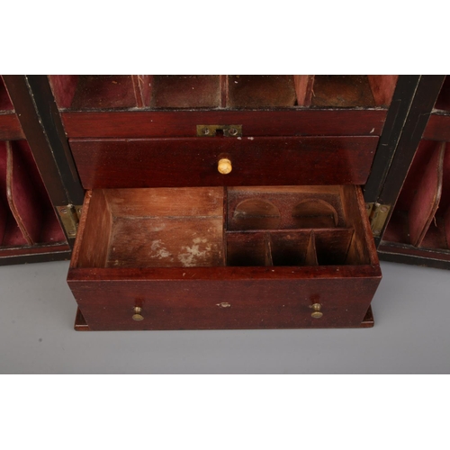 63 - An early 19th century mahogany apothecary cabinet with double door front. Having brass campaign styl... 