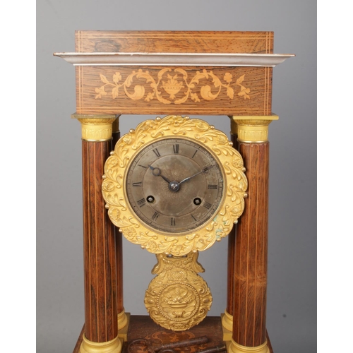 72 - A 19th century French inlaid rosewood Portico clock. Height on stand 47.5cm.