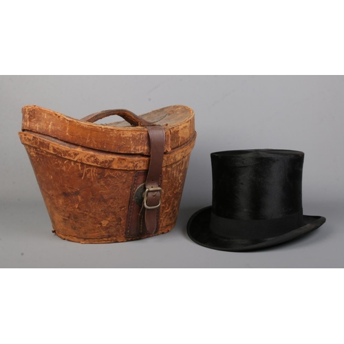 76 - A Lincoln Bennett & Co moleskin top hat in leather box. Front to back measurement 19.5cm, side to si... 