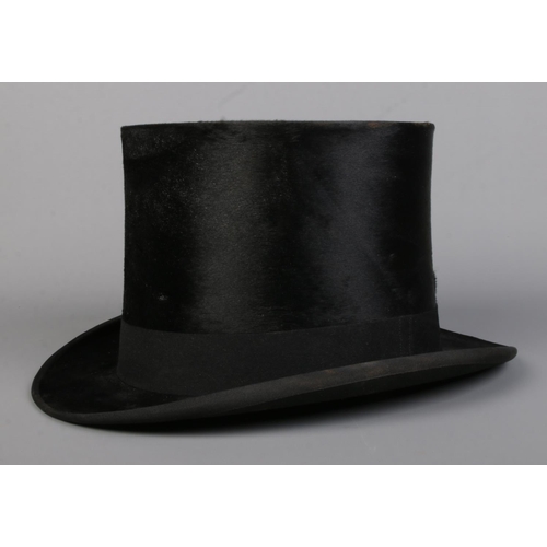 76 - A Lincoln Bennett & Co moleskin top hat in leather box. Front to back measurement 19.5cm, side to si... 