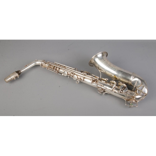 77 - An early 20th century French silver plated saxophone by Couesnon & Cie. In case.