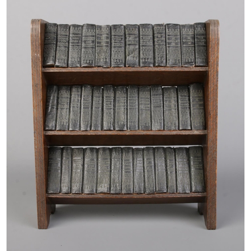 89 - A miniature bookshelf with contents of Allied Newspaper Ltd William Shakespeare volumes. Bookshelf 2... 