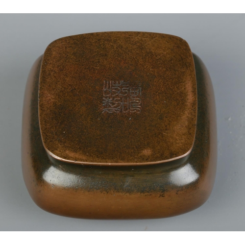 9 - A Chinese bronze hand warmer of square form, having pierced cover. Character marks to base. 5.5cm x ... 