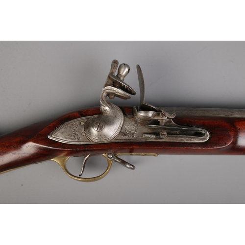 A 19th century flint lock Brown Bess musket. Stamped Tower to lock ...