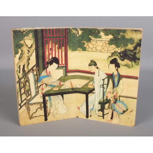 282 - A Japanese Shunga fold out book with central panel depicting couple playing Go and flanked by erotic... 