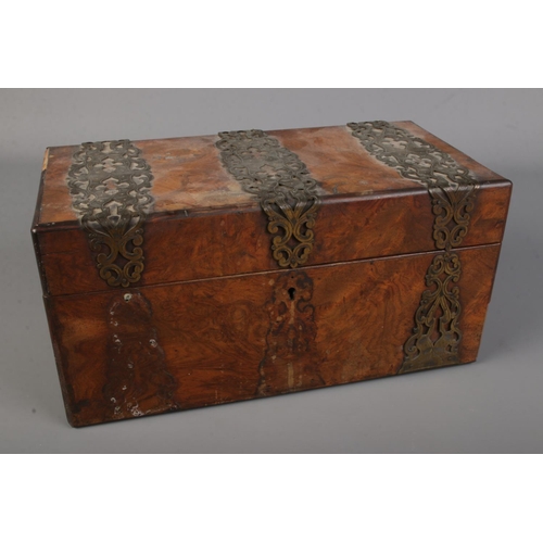 319 - A Victorian rectangular burr walnut tea caddy with brass mounts and escutcheons.