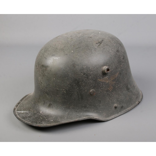 345 - A German military M16 Stahlhelm, steel helmet, having painted decals.