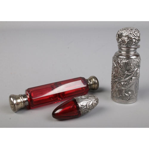 474 - A ruby coloured glass double ended scent bottle with silver top to either side together with similar... 