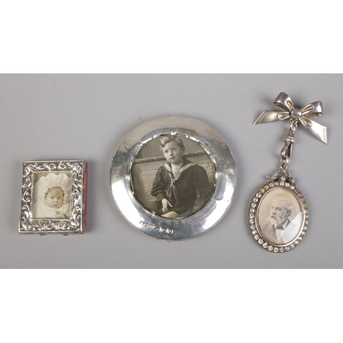 483 - A collection of three small silver picture frames including brooch example.