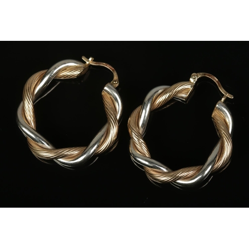 493 - A pair of 9ct gold twist hoop earrings. Total weight 5.5g.