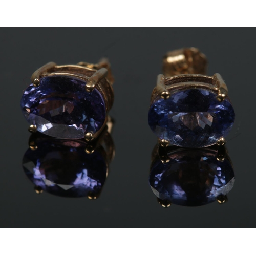 497 - A pair of 9ct gold oval cut tanzanite stud earrings. Total weight 1.4g.