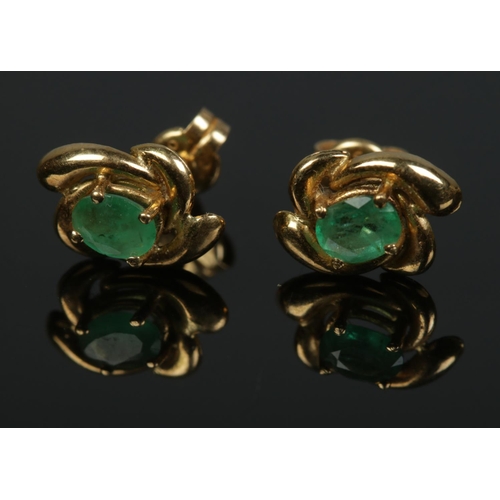 498 - A pair of 18ct gold and emerald stud earrings. Total weight 1.3g.