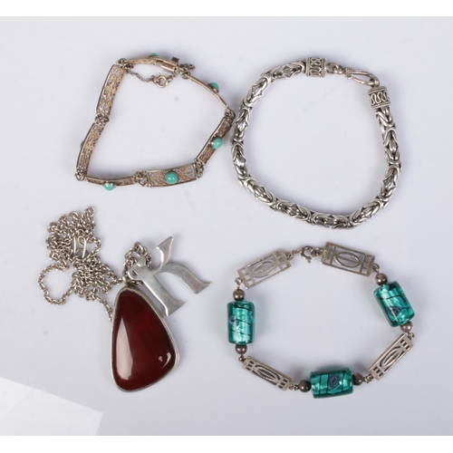 505 - A collection of silver jewellery to include carnelian pendant on chain and three bracelets. One brac... 