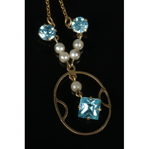 551 - A 9ct gold Edwardian style pendant on chain featuring simulated pearls and three blue paste stones. ... 