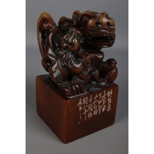 556 - A Chinese carved soapstone chop wax seal stamp surmounted with Foo dog with pup in original presenta... 