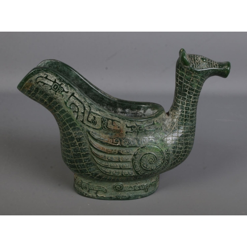 557 - An intricately carved Chinese jadeite ritual wine ewer formed as a water bird. Approx. height 17cm.