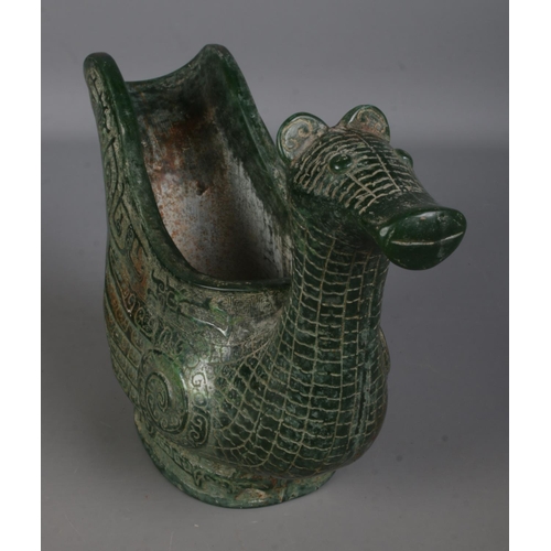 557 - An intricately carved Chinese jadeite ritual wine ewer formed as a water bird. Approx. height 17cm.