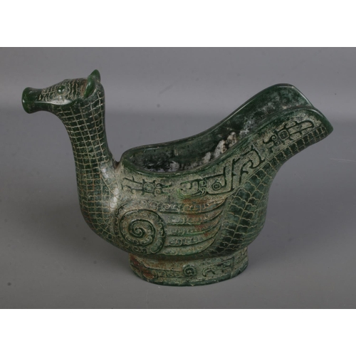 557 - An intricately carved Chinese jadeite ritual wine ewer formed as a water bird. Approx. height 17cm.