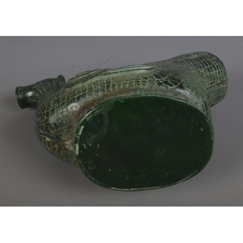 557 - An intricately carved Chinese jadeite ritual wine ewer formed as a water bird. Approx. height 17cm.