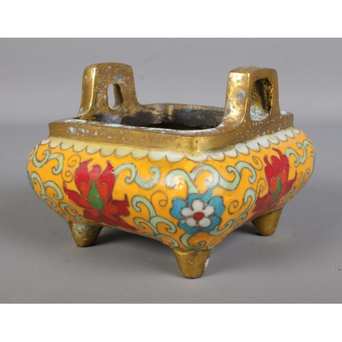 558 - A Chinese bronze censor featuring cloisonne decoration and raised on four feet. Character mark to ba... 