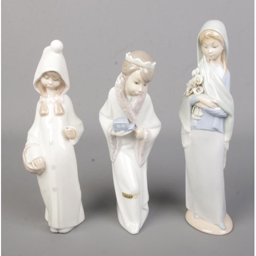 559 - Three Lladro ceramic figures to include King Gasper and Shepard from a nativity scene.