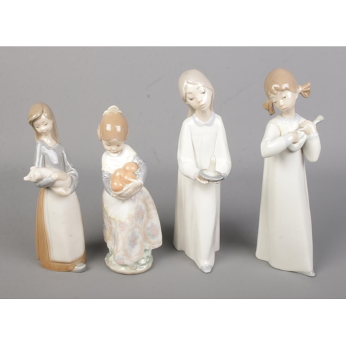 560 - Four Lladro ceramic figures to include Valencia Girl with basket of oranges and Girl with Pig.