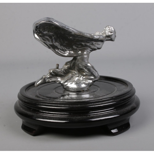 567 - A kneeling Spirit of Ecstasy Rolls Royce car mascot mounted on oriental wooden stand. Approx. height... 