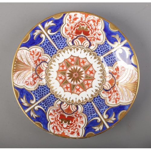 569 - A collection of early 19th century Crown Derby porcelain plates/bowls decorated in an imari pattern.