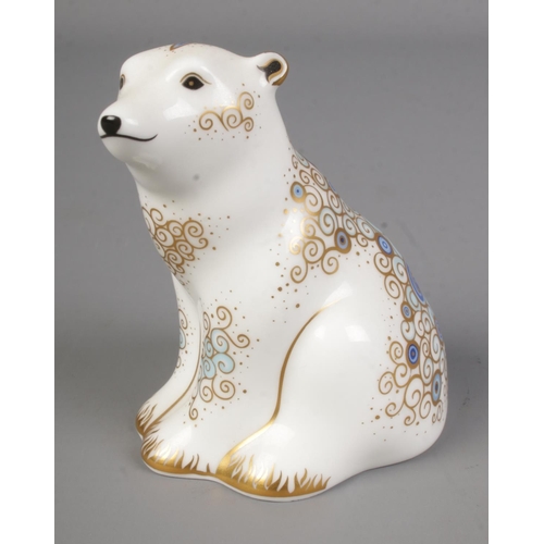 570 - A Royal Crown Derby polar bear sitting paperweight with gold stopper.