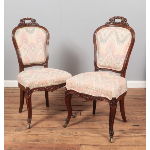 593 - A pair of Victorian carved mahogany parlour chairs.