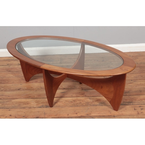 597 - A G Plan Astro style teak coffee table with glass top. Approx. dimensions 122cm x 66cm x 42cm.