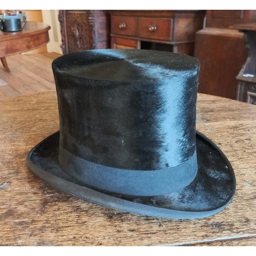 76 - A Lincoln Bennett & Co moleskin top hat in leather box. Front to back measurement 19.5cm, side to si... 